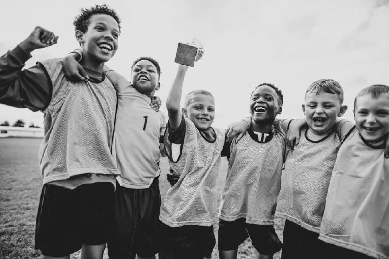 Youth athletes celebrating a championship win together